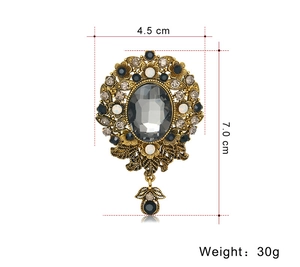 Detailed retro gold flower brooch with grey crystals, measures 4.5cm by 7.0cm