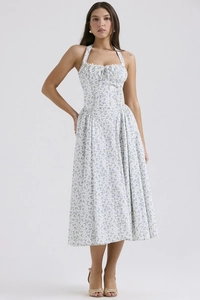 Detailed view of the blue floral print and light fabric of the white midi dress