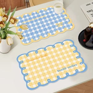 Checkered waterproof leather placemats with scalloped edges in blue and yellow colors