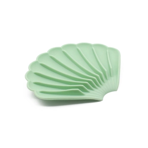 Detail of light green shell shaped silicone soap dish with non-slip drainage ridges