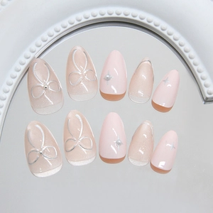 Pink cat eye press-on nails with 3D pearls, silver bows and glitter star accents