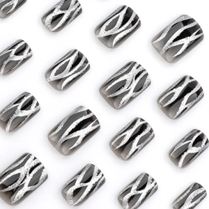 Black gradient press-on nails with silver glitter flame patterns in short square shape