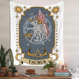 Detail of Taurus zodiac tapestry with astrology symbols in a cozy bohemian room setup