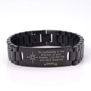 Detail of black stainless steel graduation bracelet with engraved compass and quote