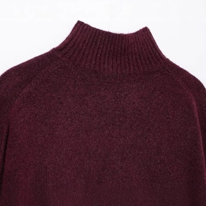 Close-up of stylish burgundy turtleneck knit sweater showing fine texture and neckline