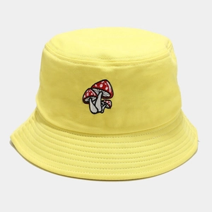 Détail de la broderie champignon sur bob en coton jaune avec texture en sergé