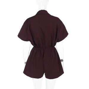 Detail of burgundy romper featuring shirt collar and elasticated waist for slim fit