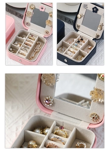 Detail view of pink and blue jewelry boxes featuring mirrors and soft velvet compartments