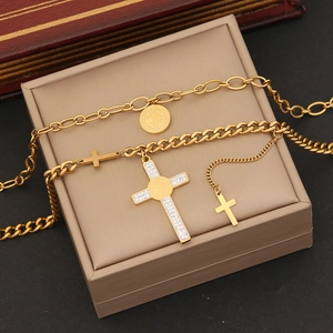 Golden stainless steel layered cross and coin pendant necklace set with crystal accents