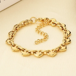 Detail view of heart-shaped links on 18k gold-plated bracelet with adjustable chain
