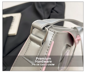 Detail of silver metallic shoulder bag with pink trim and silver D-ring buckle