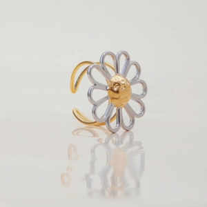 Macro view of a two-tone steel flower open ring with gold and silver petals