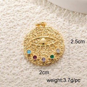 Macro shot of gold evil eye pendant with multicolored zircons on stone background