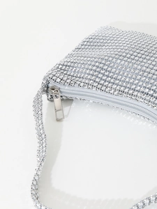 Close-up of sparkling silver rhinestone mesh and metallic zipper on mini evening bag