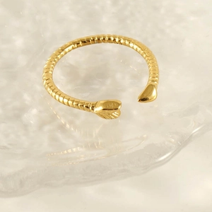 Elegant 18k gold-plated snake-shaped stainless steel ring with spiral texture on water background