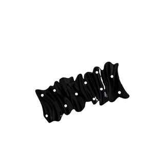 Glossy black wavy hair clip with cream polka dots and durable metal duckbill clamp