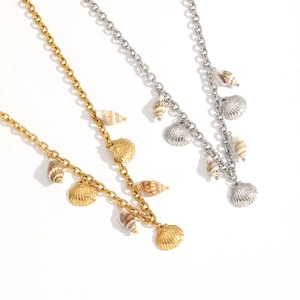 Golden and silver shell necklace set with sea charms on a minimalist white background
