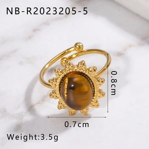 Detail of adjustable gold ring with tiger eye stone and sunflower pattern relief