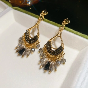 Close-up of vintage drop earrings with black crystals and grey faceted glass beads