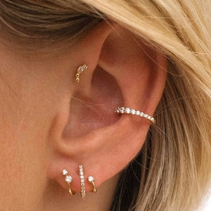 Close-up of golden S925 sterling silver hoop earrings set with sparkling zircon stones