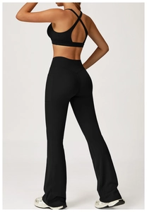 Detail of black cross-back sports bra and flared yoga leggings with side pockets