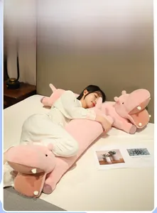 Close-up of a long pink hippo plush pillow showing its soft texture and cute details