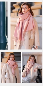 Fashionable long pink cashmere-like scarf with tassels shown in a city street setting