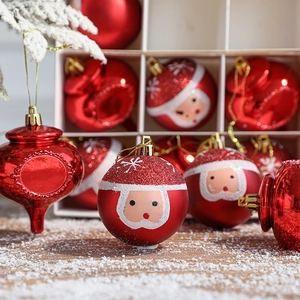 Set of 12 red Christmas ornaments with Santa motifs and glossy finish on artificial snow