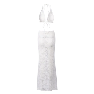 Detail of white floral lace texture on halter neck top and high-waist maxi skirt set