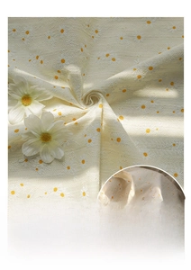 Detail showing the textured seersucker fabric and daisy floral print on the tote bag