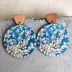 Vintage bohemian wood earrings with blue floral patterns and brown circular pendants