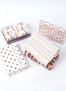 Detailed view of colorful heart and star pattern gift wrapping paper for birthday boxes