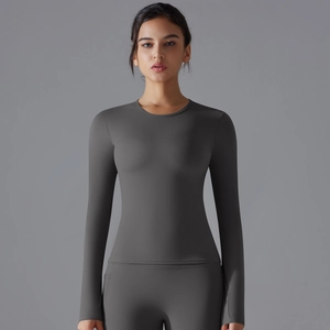 Detail of dark grey yoga top featuring functional thumb holes and slim fit long sleeves