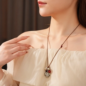 Detail of bohemian heart stone pendant necklace with ethnic beads on model