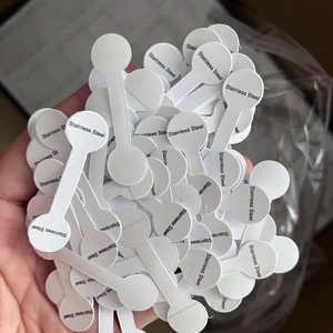 Macro shot of multiple white adhesive jewelry tags printed with Stainless Steel label