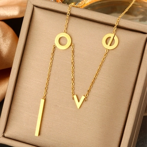 Close-up of gold LOVE pendant necklace with pearls on champagne satin in jewelry box