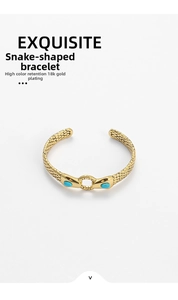Detailed macro view of 18k gold plated snake bangle with green turquoise eyes and scale texture