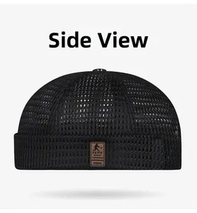 Detail of breathable mesh texture and brown leather patch on black summer brimless hat