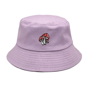 Close-up of red mushroom embroidery on lavender cotton bucket hat with parallel stitching