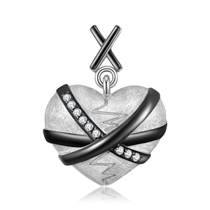 Macro detail of 925 sterling silver broken heart pendant with zircon and matte black finish
