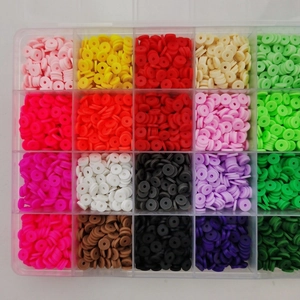 Flat lay view of 20 color polymer clay heishi beads set in a transparent plastic storage box