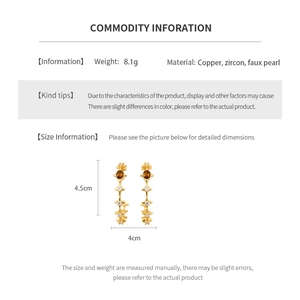 Detail view showing dimensions and weight of gold C-shaped earrings with tiger eye stone
