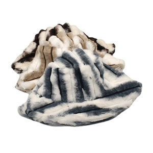 Close-up of plush striped bucket hats in faux fur texture with cozy winter colors