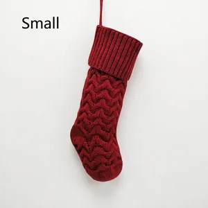 Detail of red knit Christmas stocking with wavy pattern and hanging loop in small size