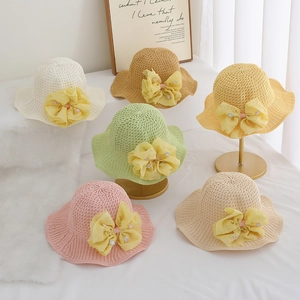 Detailed display of assorted summer straw sun hats with large fabric flowers for girls