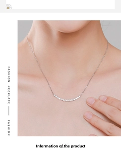 Close-up of elegant S925 sterling silver clavicle chain with curved diamond pendant