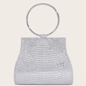 Detailed macro view of sparkling silver rhinestone evening bag with silver metal handle