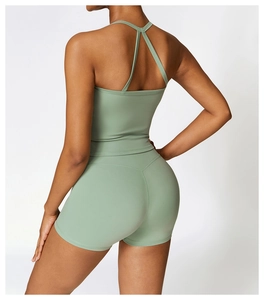 Detail of the light green sports vest with crossed back straps and moisture-wicking fabric