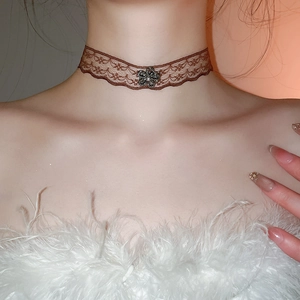Detail of vintage brown lace choker with metal flower and pearl on a neck model