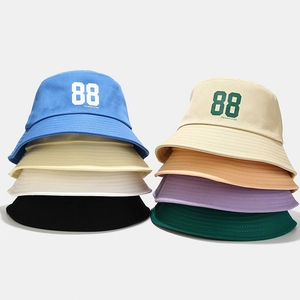 Multiple colorful cotton bucket hats featuring 88 embroidery in a stylish stacked display